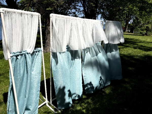 Portable puppet theater with curtains set up outdoors