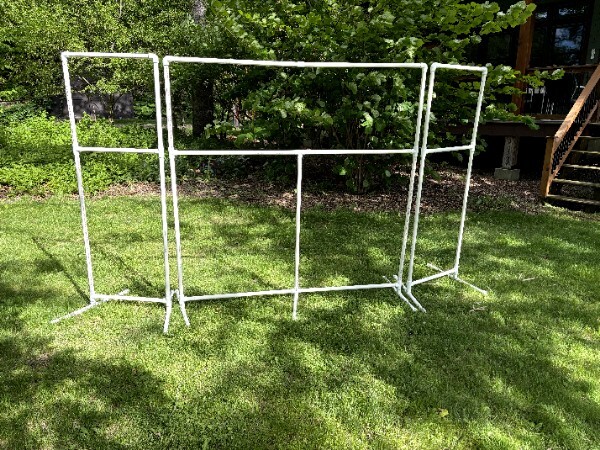 PVC pipe frame for a puppet theater, assembled outdoors on a lawn