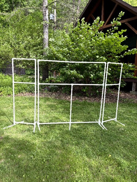 Wide view of PVC puppet theater frame on lawn