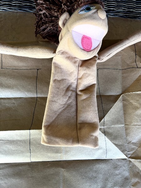 Sharpie outline sketched on a paper bag showing the puppet body shape