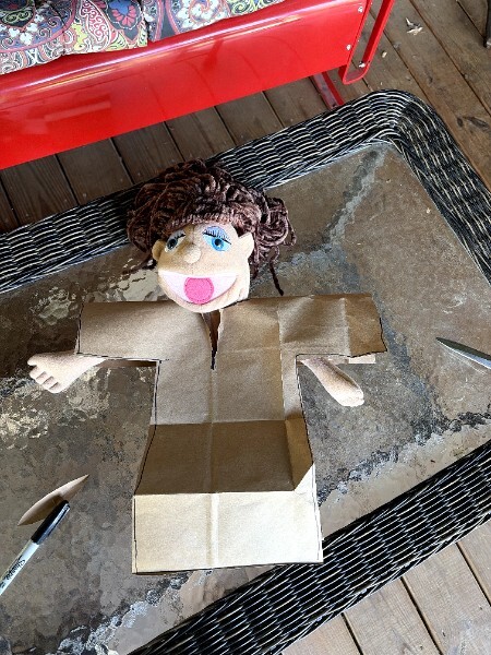 Puppet wearing the paper bag pattern during a fit check